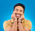 Happy, excited man and cute smile portrait in studio with Asian model with teeth and joy. Blue background, male person and casual fashion with handsome and friendly guy with modern style and wow face.