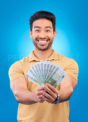 Buy stock photo Money, portrait and man or winner with bonus offer, financial success and winning, finance loan or lottery fan. Young asian person with savings, cash and profit isolated on studio, blue background