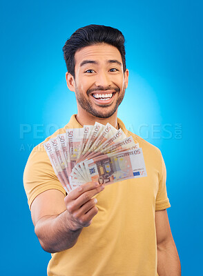 Buy stock photo Money fan, portrait and man or winner with bonus offer, financial success and winning, finance loan or lottery. Asian person with savings, winning cash and profit isolated on studio, blue background