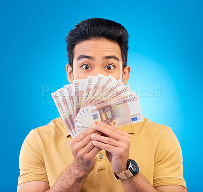 Buy stock photo Money, fan and man with wow face isolated on blue, studio background for winning, cash surprise or financial profit. Lottery, gambling secret and asian person winning, bonus and cashback in portrait