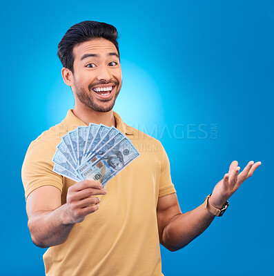 Buy stock photo Money, studio and portrait of happy man excited for dollar bills, reward or bonus cash salary, giveaway or prize. Financial freedom, winner or person smile for income, revenue or blue background win