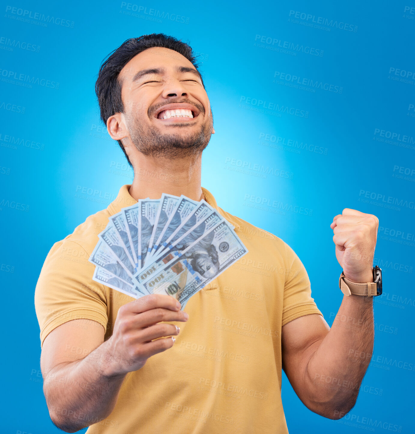 Buy stock photo Money, studio and man excited, cheers and smile for dollar bills, financial achievement award or bonus prize. Cash, competition winner and person happy for income, revenue or pay on blue background