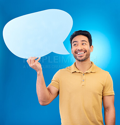 Buy stock photo Man, speech bubble and thinking in studio with smile for opinion, social media and poster by blue background. Indian guy, student and model with paper, mock up space and cardboard sign for promotion