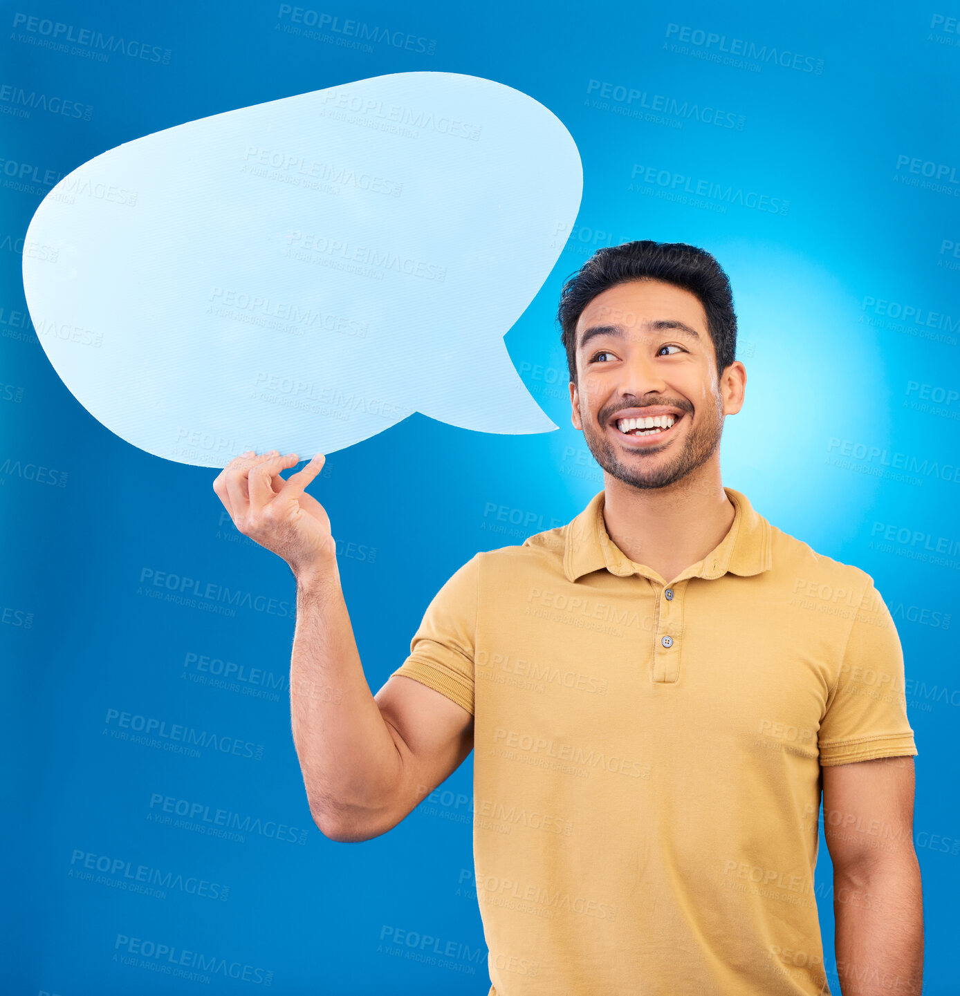 Buy stock photo Man, speech bubble and thinking in studio with smile for opinion, social media and poster by blue background. Indian guy, student and model with paper, mock up space and cardboard sign for promotion