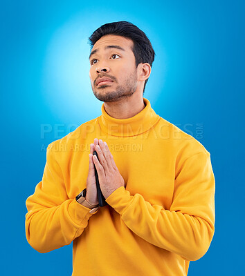 Buy stock photo Peace, man with hand gesture and praying against a blue background for worship. Thank you or faith, spiritual growth or meditation and young male person with emoji hands sign for religion in studio