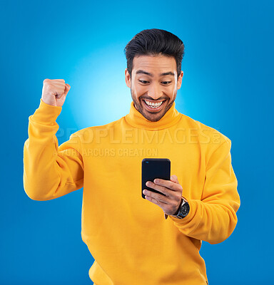 Buy stock photo Winner, surprise and excited Asian man with phone in studio for online bonus, competition and prize. Success, smartphone and happy male person on blue background for promotion, winning and good news