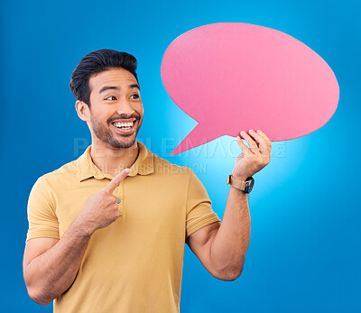 Buy stock photo Pointing, speech bubble and thinking Asian man for communication, feedback or chat. Excited, talk and a person with a board for conversation isolated on a blue background in a studio with space