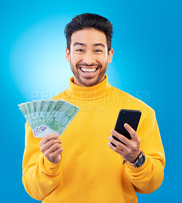 Buy stock photo Success, money and portrait of Asian man with phone in studio for online bonus, competition and lottery. Winner, finance and male person on blue background with cash for promotion, winning and deal
