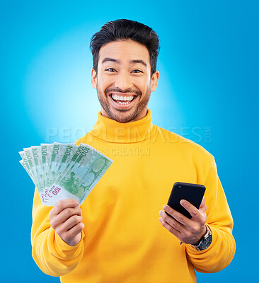 Buy stock photo Man, phone and money fan in studio with prize, esports gambling or happy in portrait by blue background. Young asian guy, winner and cellphone with cash, fintech or crypto with profit, bonus or goals