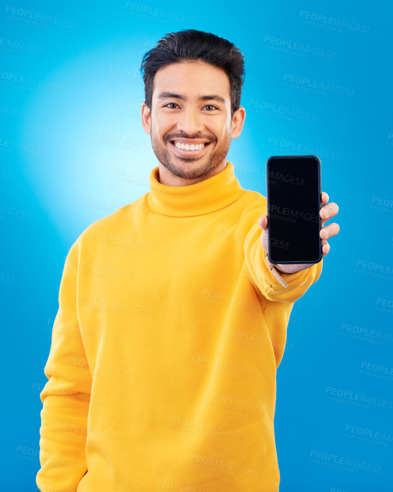Buy stock photo Advertising, portrait of man with smartphone and in blue background happy for social networking. Online communication, technology or marketing, branding and male person with cellphone app in studio
