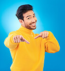 Man, studio portrait and point at you with smile, choice and recruitment with fashion by blue background. Young Indian guy, gen z student and finger for decision, hiring and opportunity with clothes