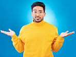 Confused, shrug and portrait of a man in a studio with an unsure, doubt or question expression. Uncertain, choose and headshot of a male model with a decision gesture isolated by a blue background.