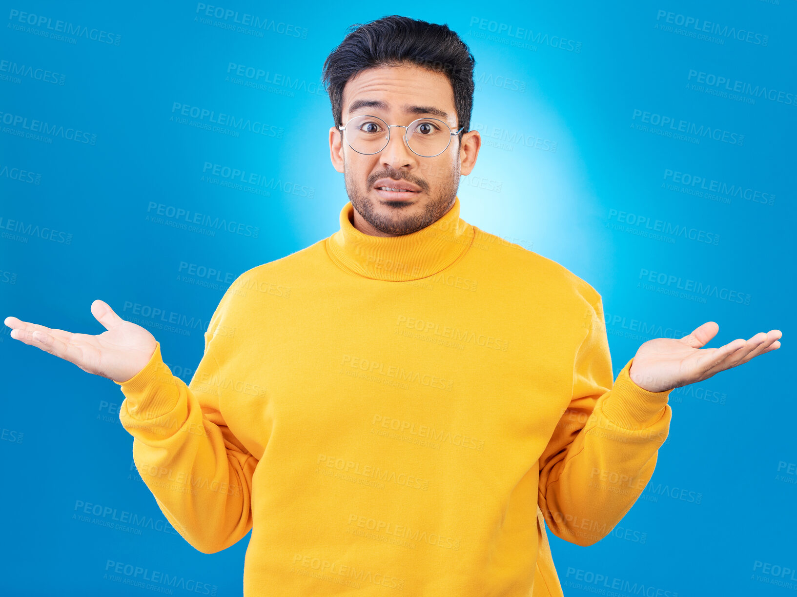 Buy stock photo Confused, shrug and portrait of a man in a studio with an unsure, doubt or question expression. Uncertain, choose and headshot of a male model with a decision gesture isolated by a blue background.