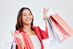 Fashion, studio or happy woman with shopping bags for retail sale, product offer or discount deal. Choice, customer or girl shopper holding gift, package or products on promotion on white background