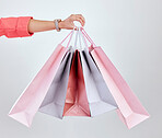 Fashion, studio or hand of woman with shopping bags for retail sale, product offer or discount deal. Choice, customer or girl shopper holding gift, package or present on promotion on white background