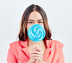 Portrait, lollipop and woman with sweets, happiness and confident girl on a white studio background. Face, female person or model with candy, dessert and cover with treats, cheerful and confectionary