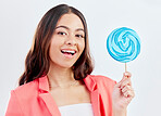 Portrait, smile and woman with a lollipop, candy and promotion against a white studio background. Face, female person and happy model with dessert, treats and sweets with joy, product and aesthetic