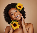 Portrait, skincare and sunflower with a model black woman in studio on a brown background for cosmetics. Face, beauty or natural and a happy young female person with a flower in her afro hair