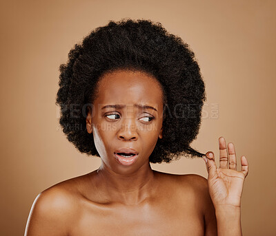 Buy stock photo Worry, black woman and hair problem for afro in studio isolated on a brown background. Damage, hairstyle and sad African model with split ends, frizz and loss after natural salon treatment for beauty