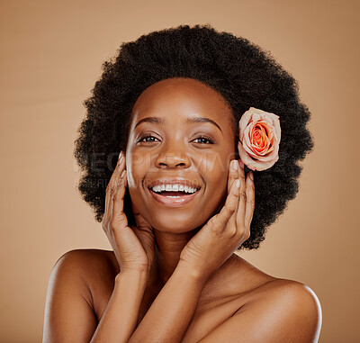 Buy stock photo Happy, flower and portrait of a black woman with skincare, clean glow and wellness. Smile, touching face and an African model with floral beauty for skin isolated on a brown background in a studio