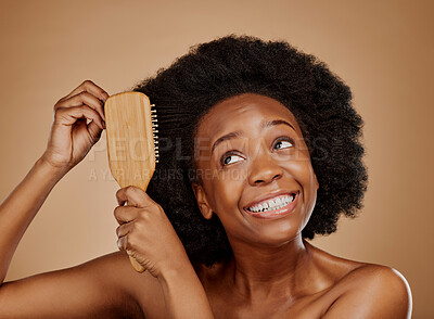Buy stock photo Black woman, hairstyle and smile for brush in studio, brown background and treatment for curly texture. Natural beauty, confidence and happy young african female model comb clean or healthy afro hair