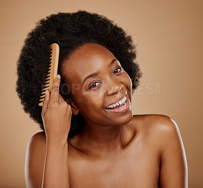 Buy stock photo Black woman, portrait and hairstyle brush in studio, brown background and grooming of curly texture. Natural beauty, happy face and young african female model with comb tools for aesthetic hair care