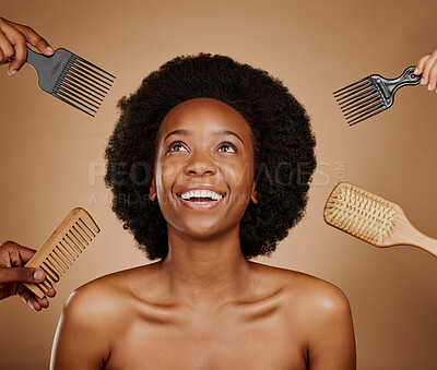 Buy stock photo Hair, comb and brush selection with a black woman in studio on a brown background for beauty or cosmetics. Salon, afro or haircare with hands at a hairdresser and an attractive young female model