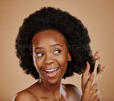 Buy stock photo Hair care, happy black woman and brush in studio, brown background and treatment of curly texture. Natural beauty, smile and face of young african female model with comb, hairstyle and grooming tools