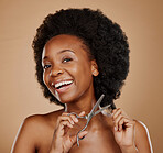 Portrait, happy and black woman cutting hair as hairdresser, damage or maintenance for afro style. Smile, salon and an African girl or model with scissors for hairstyle isolated on studio background