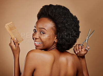 Buy stock photo Portrait, back and a black woman with a comb and scissors in studio on a brown background for a haircut. Smile, afro and haircare with a happy young female person looking excited at the salon