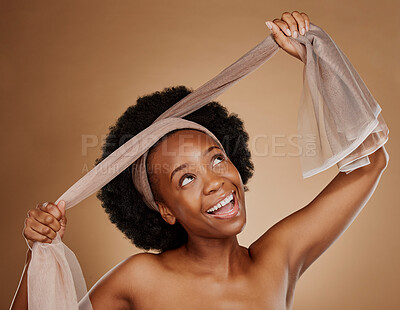 Buy stock photo Tie, afro or happy black woman with headband in studio for beauty, cosmetics or wellness on brown background. Model, smile or excited African girl with scarf for hair care, hairstyle or self love
