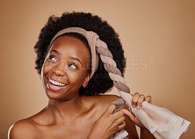 Buy stock photo Happy, afro or black woman with headband thinking of change or beauty in studio on brown background. Tie, smile or thoughtful African girl model excited by haircare idea, scarf hairstyle or self love