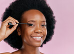 Face, makeup and black woman with mascara, smile and beauty in studio isolated on a pink background mockup. Portrait, eyelash cosmetics and African model apply facial treatment, wellness or aesthetic