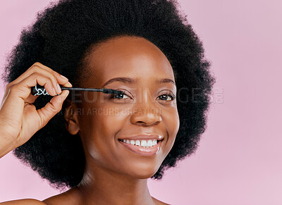 Buy stock photo Face, makeup and black woman with mascara, smile and beauty in studio isolated on a pink background mockup. Portrait, eyelash cosmetics and African model apply facial treatment, wellness or aesthetic