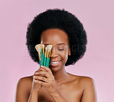 Buy stock photo Face, makeup and black woman with brushes, eyes closed and smile in studio isolated on a pink background. Skincare, facial cosmetics and African model with tools for foundation, powder and beauty.