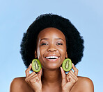 Skincare portrait, kiwi and woman for beauty, cosmetics and natural product, healthy glow and vitamin c promotion. Face of African person or model, fruits and dermatology on a studio, blue background