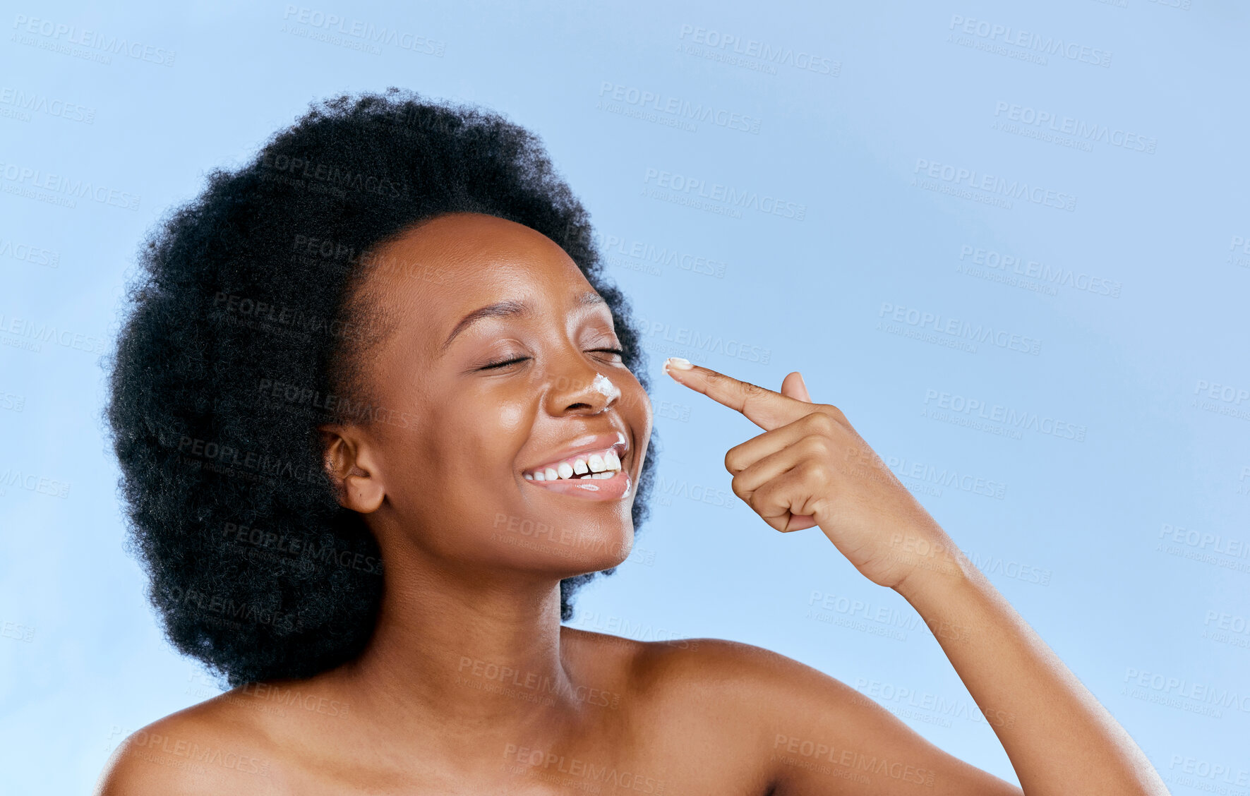 Buy stock photo Black woman, smile with cream on nose, beauty and skincare with cosmetics on blue background. Moisturizer, lotion and product for skin with glow and happiness, female model and dermatology in studio