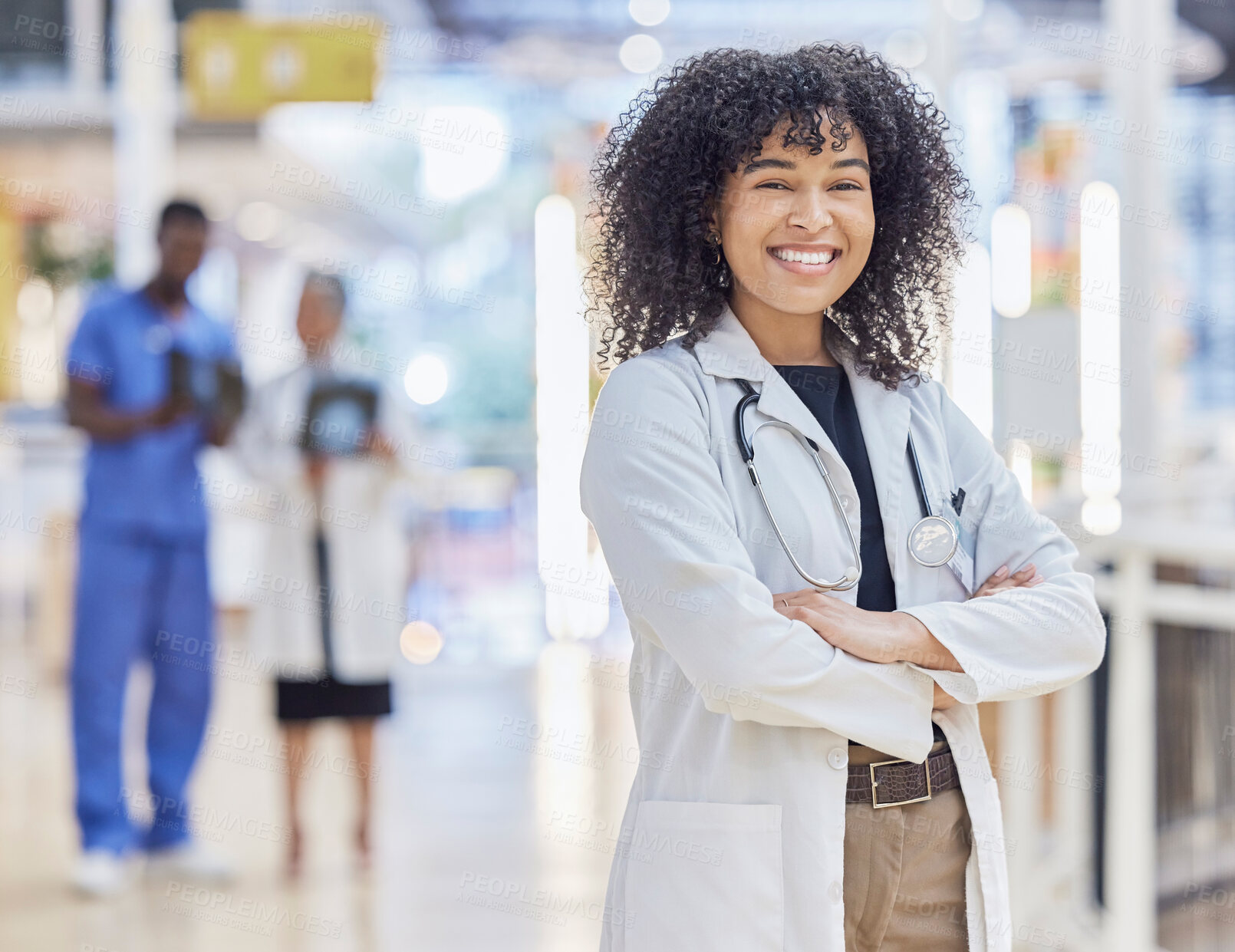 Buy stock photo Portrait, happy doctor and confident woman in hospital for healthcare. Face, arms crossed and African medical professional, surgeon or physician with smile, wellness and pride for career with bokeh.