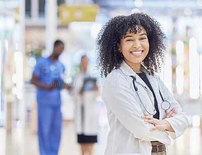 Buy stock photo Doctor, portrait and woman smile with arms crossed in hospital for healthcare, wellness and pride for career. Face, confidence and African medical professional, surgeon or happy employee in clinic.