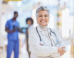 Doctor, portrait and senior woman with arms crossed in hospital for healthcare, wellness and pride for career. Face, confidence and elderly medical professional, surgeon or happy worker in clinic.