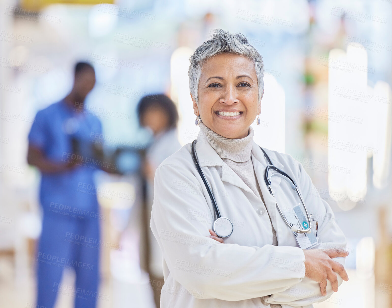 Buy stock photo Doctor, portrait and senior woman with arms crossed in hospital for healthcare, wellness and pride for career. Face, confidence and elderly medical professional, surgeon or happy worker in clinic.
