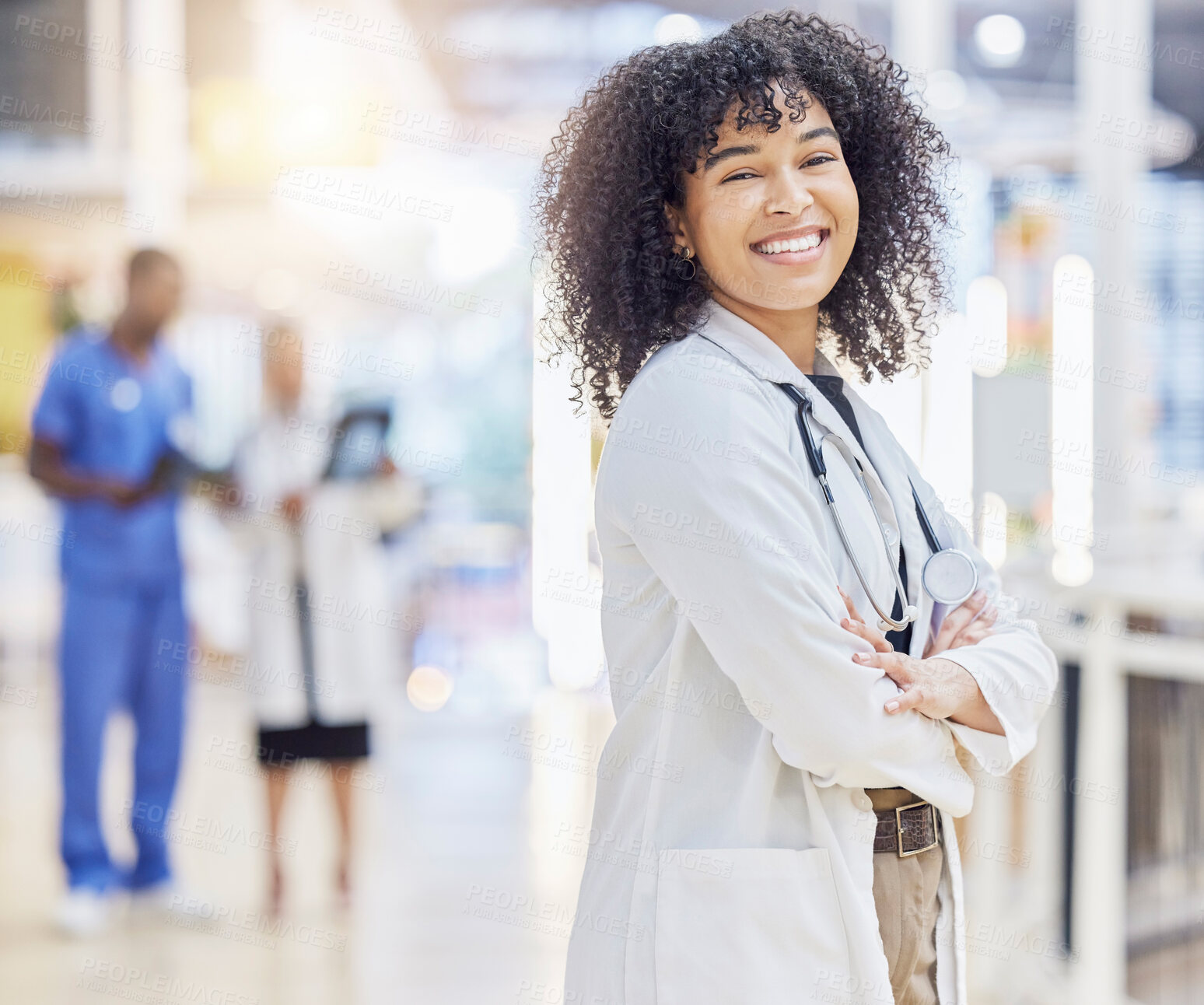 Buy stock photo Portrait, happy doctor and woman with arms crossed in hospital for healthcare. Face, confidence and African medical professional, surgeon or clinic employee with smile, wellness and pride for career.