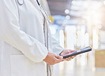 Doctor, hands and person with tablet for medical information, data research or healthcare in hospital. Closeup of physician, digital technology and planning telehealth, internet app or online results