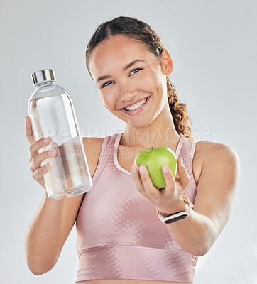 Buy stock photo Portrait, woman and fitness with apple, water and in studio for diet of healthy food, nutrition and detox for wellness goals. Happy sports model, hydration or fruit to lose weight on white background
