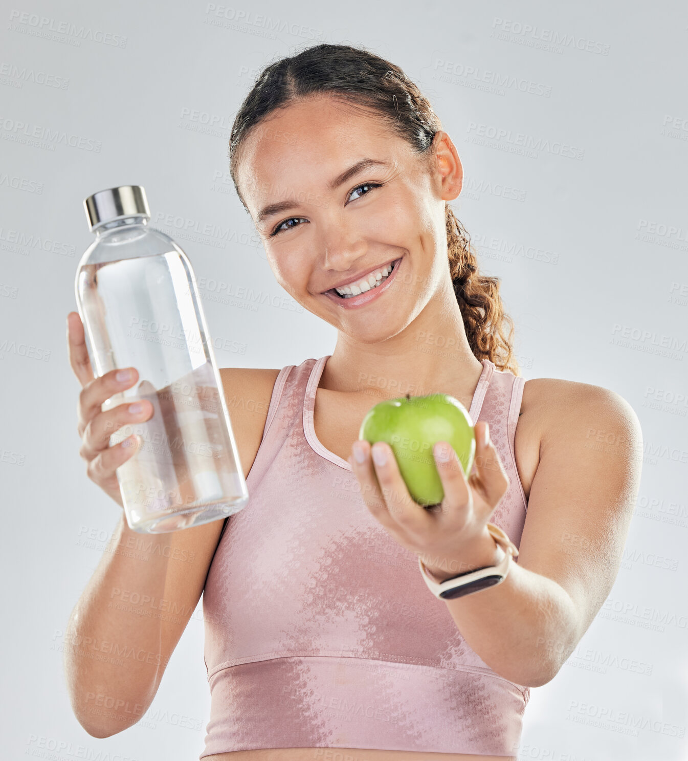 Buy stock photo Portrait, woman and fitness with apple, water and in studio for diet of healthy food, nutrition and detox for wellness goals. Happy sports model, hydration or fruit to lose weight on white background