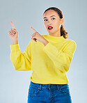 Pointing, shock and presentation with portrait of woman in studio for show, advertising and idea. Announcement, wow and deal with person on grey background for opportunity, offer and news mockup