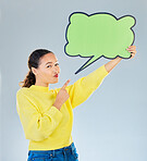 Woman, pointing and speech bubble portrait for question, social media or faq communication. Young female model with a sign or space for marketing, idea or opinion on a white studio background
