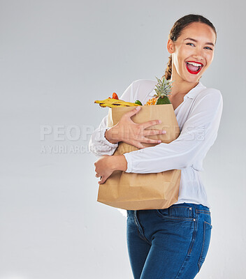 Buy stock photo Excited, portrait and woman grocery shopping for fruits on mockup space in studio isolated on white background. Sustainable bag, food and customer with vegetables for healthy nutrition in supermarket