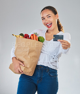 Buy stock photo Credit card, portrait and woman grocery shopping online for fruits in studio isolated on a white background. Sustainable bag, food and excited customer with digital money, ecommerce and fintech sales
