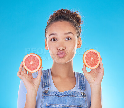 Buy stock photo Portrait, kiss and woman with grapefruit in studio isolated on a blue background. Face, fruit and person with food for healthy diet, nutrition or wellness, eating and vitamin c, benefits and vegan.